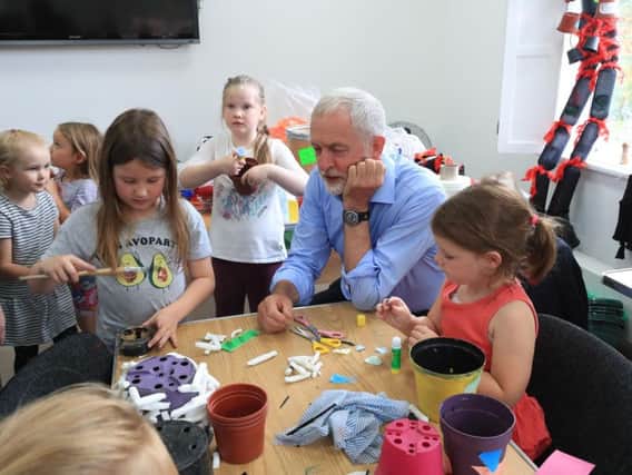 Labour leader Jeremy Corbyn joins Isla McChesney (left), 7, and her sister Thea McChesney (right), 5, during a visit to the Whittaker Museum in Rawtenstall, in the Conservative seat of Rossendale & Darwen.