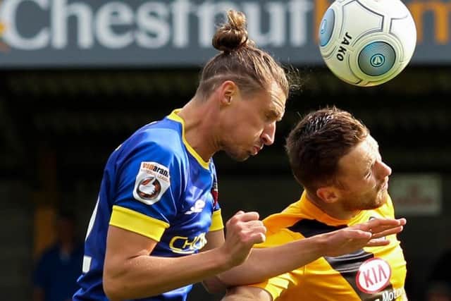 Dale Whitham battles for the ball in midfield