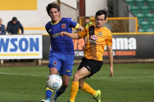 Josh Wilson clears away the ball for Chorley