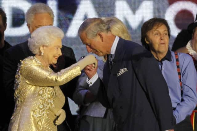 Britain's Queen Elizabeth II has her hand kissed by her son Prince Charles at the end of the Queen's Jubilee Concert in front of Buckingham Palace, London, Monday, June 4, 2012. The concert is a part of four days of celebrations to mark the 60 year reign of Britain's Queen Elizabeth II. (AP Photo/Joel Ryan)