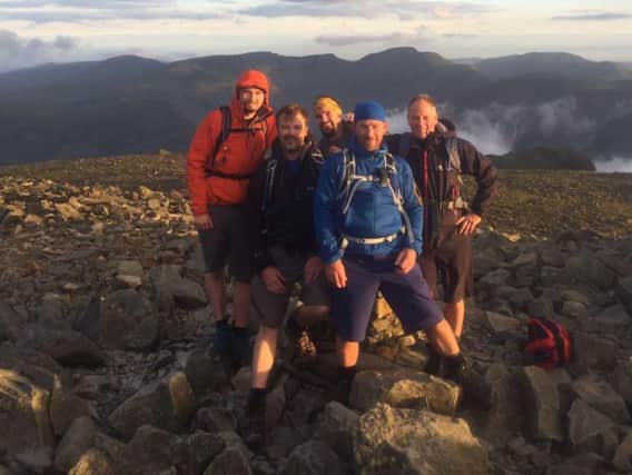 Andrew Ross (centre in blue) with the rest of his team at one of the Three Peaks
