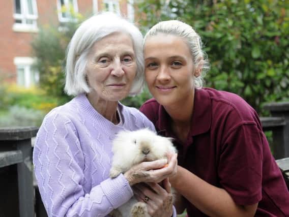 A specialist dementia care home has opened a pet therapy facility for residents. Phyllis Trimm is pictured with rabbit Tinkerbell and carer Kelly Wilson.