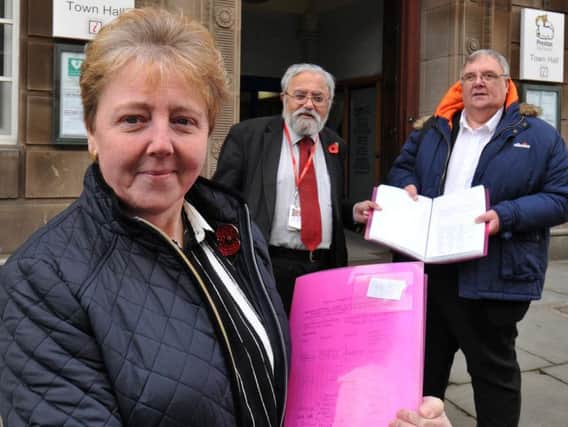 Patricia Varty hands in the petition to Couns Swindells and Saksena