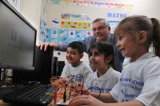 Photo Neil CrossEldon Primary holding a Super Learning Day Martin Newton coding with Amelia Gegoire, Amaan and Hannah Raheem