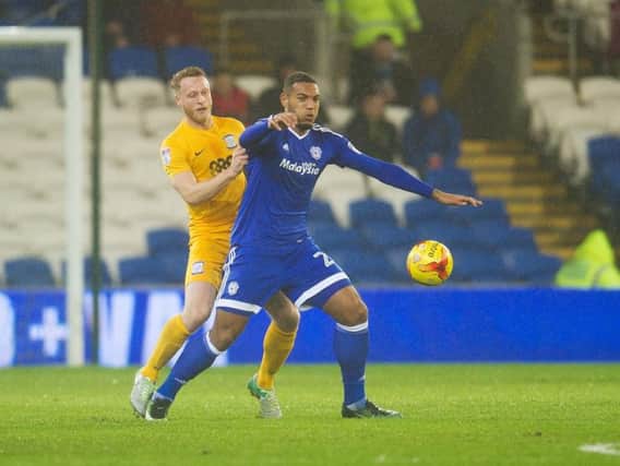 Kenneth Zohore is challenged by Tom Clarke