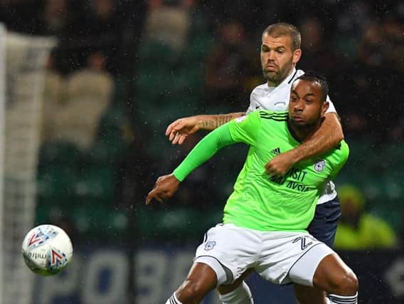 PNE midfielder John Welsh grapples with Loic Damour against Cardiff