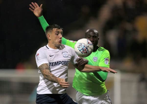 Preston North End's Jordan Hugill and Cardiff City's Sol Bamba battle for the ball.