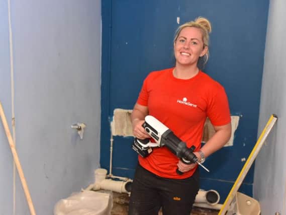England rugby star Marlie Packer fitting toilets at the Foxton Centre