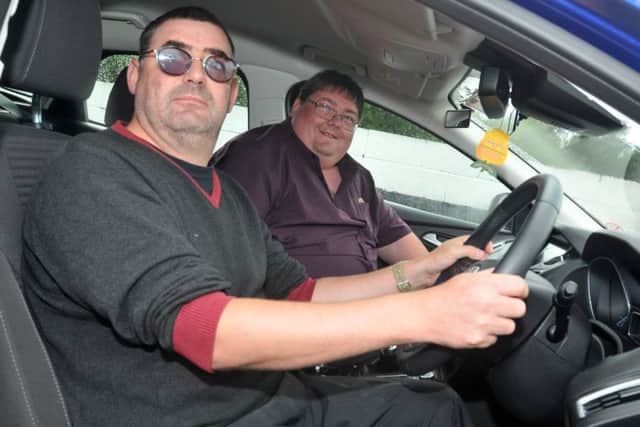 Visulally impared David Harris behind the wheel with driving instructor John Parry