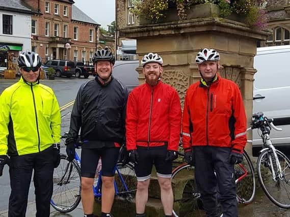 The team from Robins and Day, in Preston, takes a quick break in Settle, 36 miles in to the challenge in aid of Rosemere. Paul Walton, Will Lynes, Dave Lince and Paul Livsey