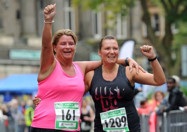 The Run Preston 10k and 5k runs set off and finish on Market Street in the town after a route that takes in Avenham Park, Preston. Friends united at the end of the 10k run. Picture by Paul Heyes, Sunday September 24, 2017.