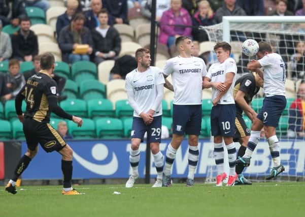 John Welsh blocks a free-kick from Jed Wallace when on duty on the end of the wall against Millwall