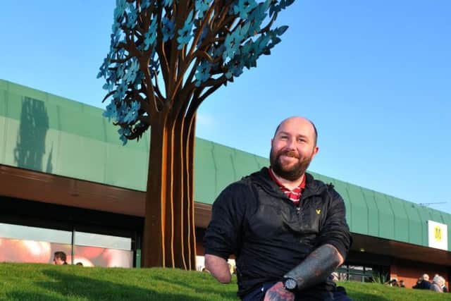 Dave Watson next to the new 20 foot iron tree landmark in Bamber Bridge