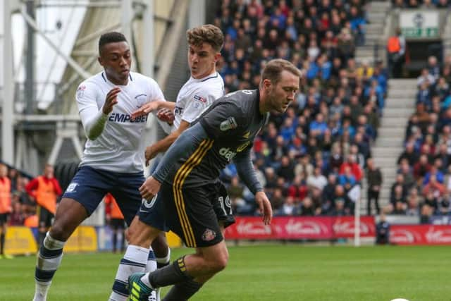 Darnell Fisher and Josh Harrop track Aiden McGeady