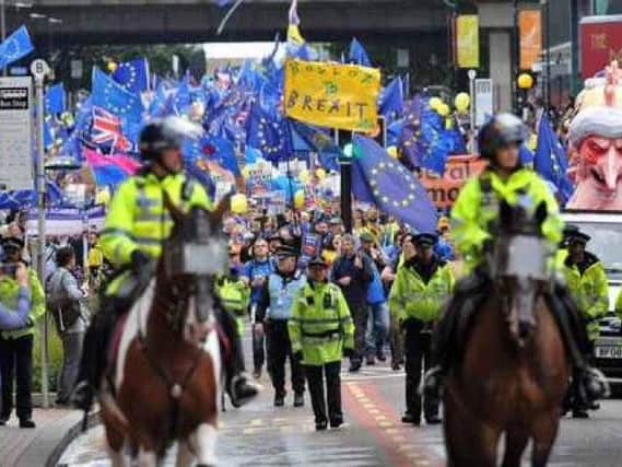 Lancashire police horse Guild, left, on duty at the Stop Brexit march in Manchester