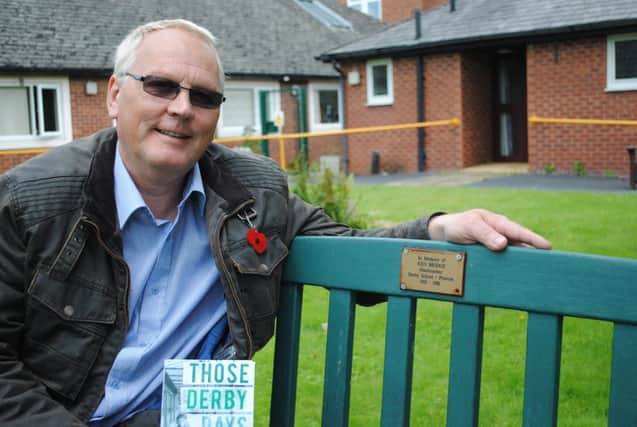 Garry Cheesbrough sat on the memorial bench to Derby Schools Headmaster Ken Bridge in the grounds of Howick House, Penwortham