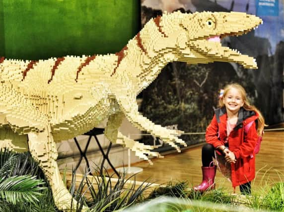 Jessica Luckiewicz poses with a Masiakasaurus