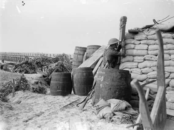 Officer of 2/4th East Lancashires observes the enemy through a trench periscope