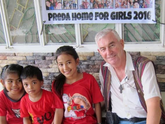 Father Shay Cullen in the Preda Foundation in Olongapo city in the Philippines, with girls who have been rescued.