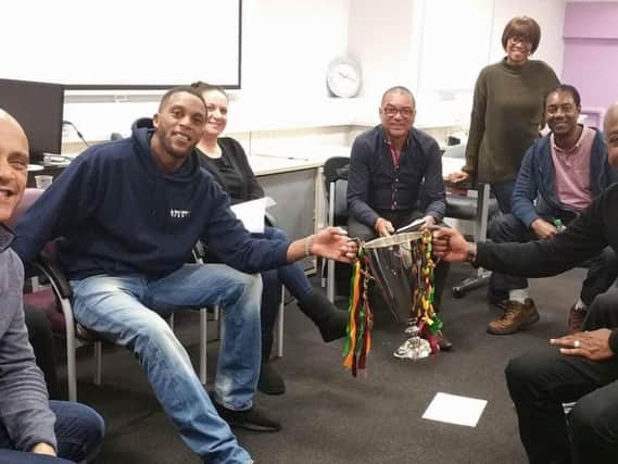 Members of Windrush are organising a football tournament to raise funds for people affected by Hurricane Maria in the Caribbean islands. Chris Bruney is pictured at the front