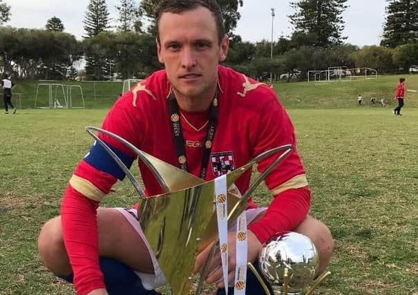 Western Knights captain Paul Lloyd with the trophies for winning the league and cup double