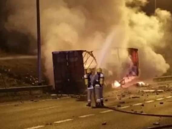 Firefighters battled the blaze at the busy junction which melted the road