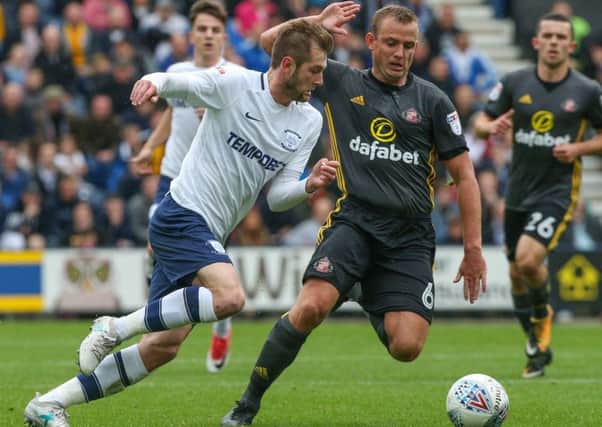 Preston North End's Tom Barkhuizen battles with Sunderland's Lee Cattermole.