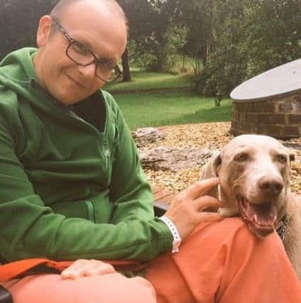 Phil Woodford being visited by his dog Vale in hospital. Vale lost an ear to cancer while Phil was in hospital