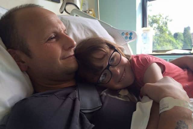 Phil Woodford enjoying being visited by his youngest daughter in hospital