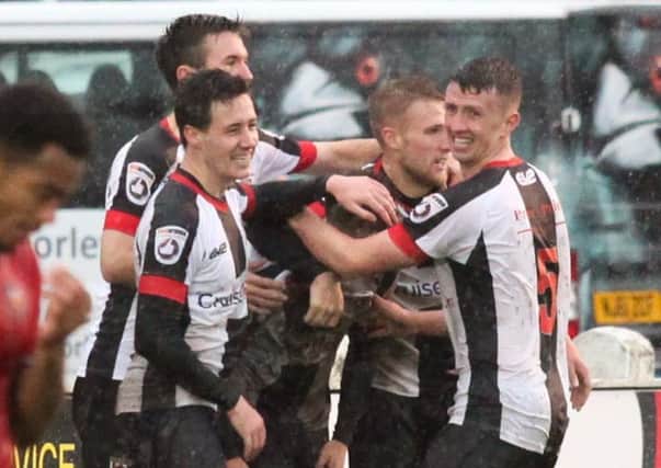 Nick Haughton is mobbed by his Chorley team mates after scoring for the Magpies