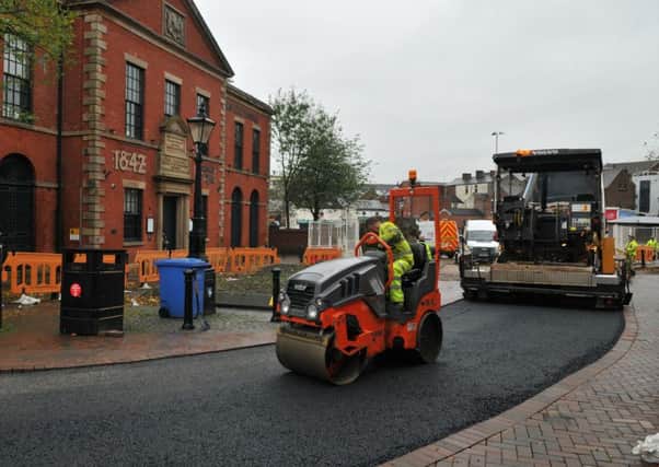 Workmen construct a new junction between Lune Street and Ringway