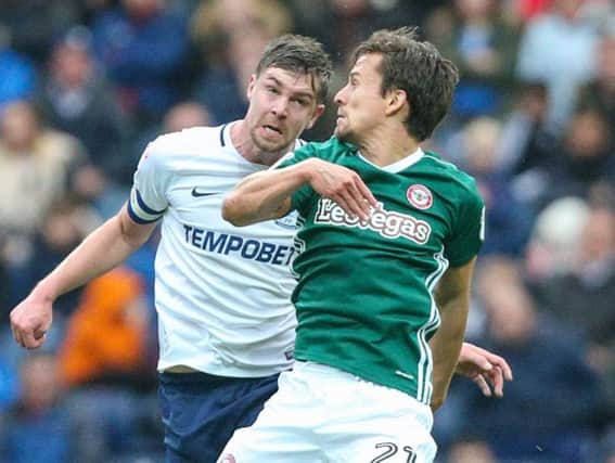 Preston North End's Paul Huntington battles with Brentford's Lasse Vibe