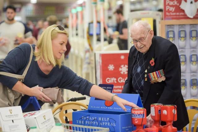 Poppy seller Ron Jones, who is 100 years old, at his selling station inside Tesco supermarket