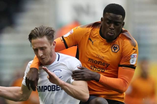 Ben Davies is challenged by Wolves midfielder Alfred N'Diaye
