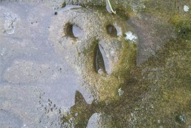 Skull and crossbones tomb of the Nutter family at the church of St Marys in Newchurch