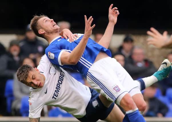 Preston striker Jordan Hugill drags Aaron Webster to the floor