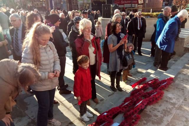 Folk gather at the foot of the cenotaph in Preston following the Remembrance Sunday commemorations