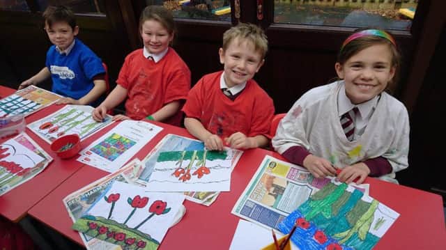 Winmarleigh CE Primary School pupils Robin, Amy, Tom and Jasmine creating pastel pictures of Flanders Fields