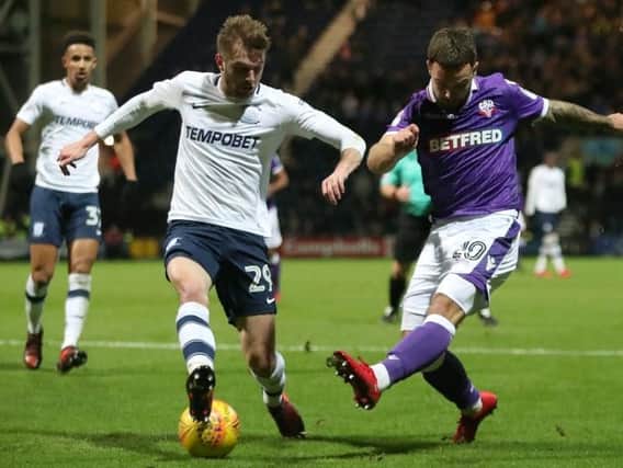 Tom Barkhuizen challenges Bolton's Adam Armstrong.