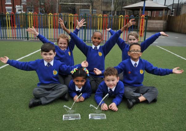 Photo Neil Cross Pupils celebrate  with the two trophies at Eldon School, Preston