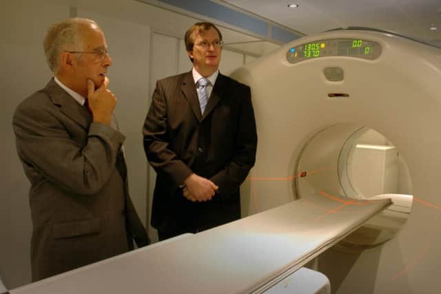 Chairman Dennis Benson and Professor Jonathan Hill look at the new scanner based in a mobile unit at RPH