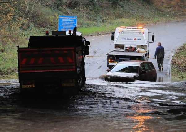 A lorry drives through flood water under a bridge in Galgate, Lancashire, as heavy rain caused widespread flooding and travel disruption. Photo credit: Peter Byrne/PA Wire