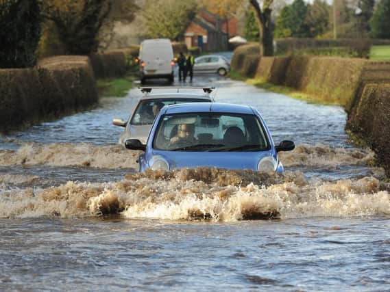 A car ploughs through flood waters in Garstang