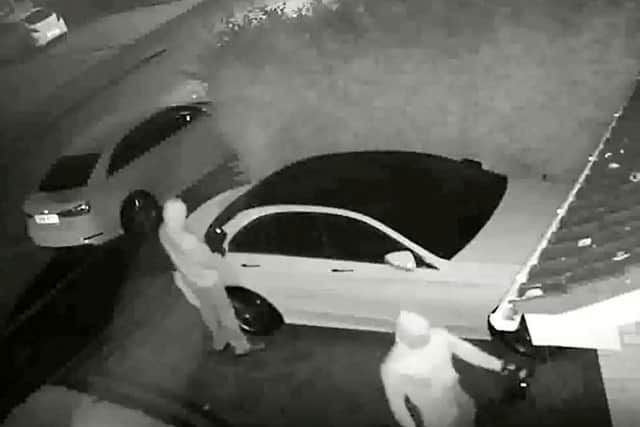 The footage shows two men pull up outside the victim's house, holding a relay box