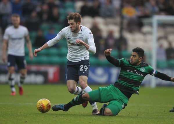 Preston winger Tom Barkhuizen is tackled by QPR skipper Massimo Luongo