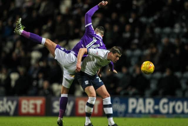 Paul Huntington battles with Gary Madine during the draw with Bolton at Deepdale.