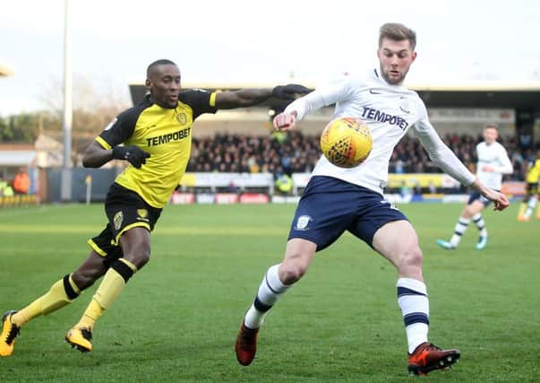 Tom Barkuizen shields the ball from Burton Albion's Lloyd Dyer