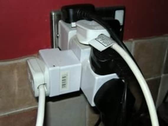 Photo of an overloaded plug socket.