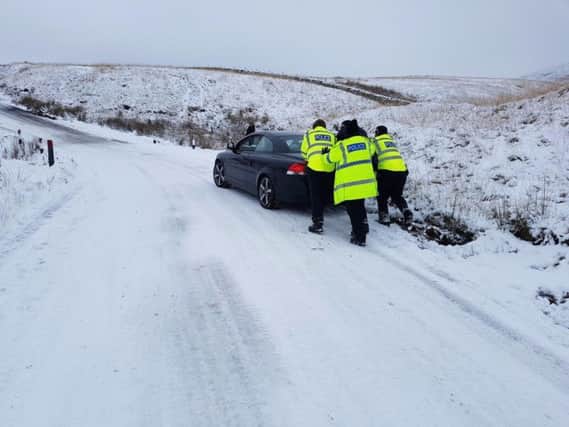 Police helping a stranded car in Rivington, Chorley. Photo: Lancashire Road Police.