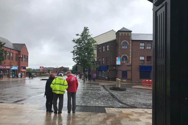 Bob Mills, blind trustee of Galloway's, and Stuart Clayton, cheief executive of Galloway's, showing Abbie Jones, BBC North West Tonight reporter, how difficult it is to cross the shared space in Preston